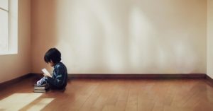 The AI image of a child studying with no furniture