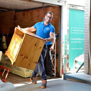 Delivery man carrying furniture